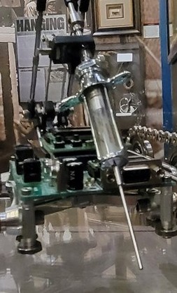 Figure 2 — Detail of the actual end effector: the glass barrel, plunger, and
forward-aimed needle of the vintage syringe.