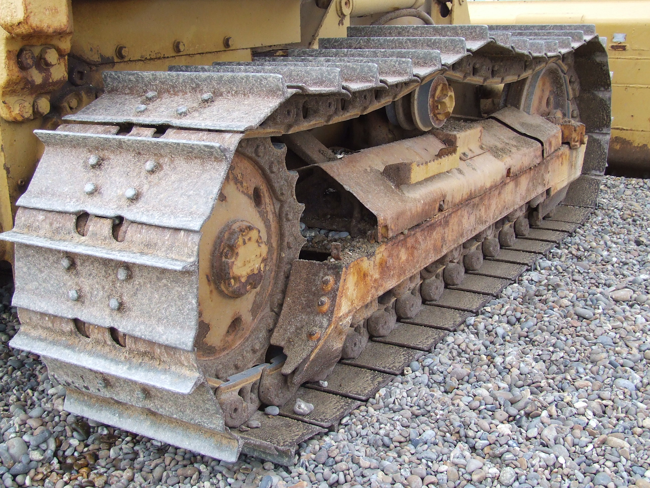 Figure 2 — A generic continuous-track (caterpillar) drive, shown for the
running-gear principle; the sculpture instead repurposes bicycle chain as its
track. File:Caterpillar track shingle.JPG by J…