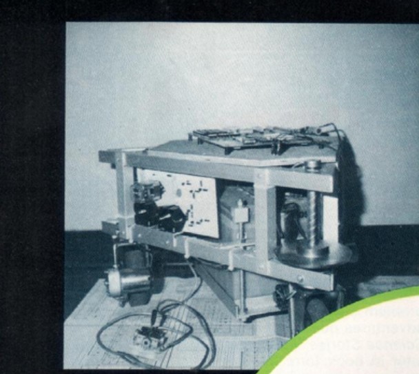 Figure 3 — Three-quarter side view of the rolling chassis during construction.
The two-tier aluminum frame profile is visible, along with a drive electronics
panel mounted to the frame and the larg…